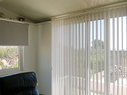 Vertical and roller blinds in conservatory 